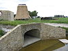 Victor (Wanswerd) under restoration, screw and smock.JPG -  Windmill Victor under restoration in 2012. In the foreground the water outlet. In the background (left to right) the brick base, the smock and the screw.
