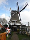 WIndmolen Formerum Terschelling -01 -  Thatched smock mill, 'De Koffiemolen' (The Coffee Mill) from 1876 at Formerum 6 on the island of Terschelling in the Netherlands.  Met riet gedekte bovenkruier met stelling, 'De Koffiemolen' uit 1876 aan Formerum 6 op Terschelling.