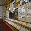 Int. woongedeelte, voorheen winkel, wand achter de toonbank met oud winkelinterieur - Velp - 20318588 - RCE -  Int. woongedeelte, voorheen winkel, wand achter de toonbank met oud winkelinterieur 