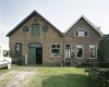 Voorgevels van de werkplaats met aangebouwde dienstwoning