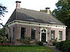 Hoekpand met dwars voorhuis onder schilddak en schuurvormige achterbouw