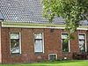 Kop-hals-rompboerderij met groot voorhuis onder zadeldak tussen topgevels