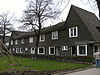 Zeven arbeiderswoningen in een symmetrische straatwand