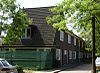 Twaalf arbeiderswoningen in symmetrische straatwand