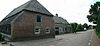 Schaft - Dorpsstraat 112 Boerderij.JPG -  Boerderij van het Kempische langgeveltype op L-vormige plattegrond, onder rieten wolfdak met voet van pannen. Ramen met kleine roedenverdeling en luiken. Jaartalstenen 1771. 