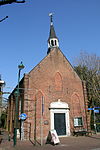 Budel - Dr. Anthonie Mathijssenstraat 7 Nederlands Hervormde kerk.JPG -  In 1809 stond koning Lodewijk Napoleon de Hervormde Gemeente Budel-Maarheeze-Soerendonk-Gastel 6.000 gulden toe voor de bouw van een kerk te Budel. Het geld werd pas in 1812 ontvangen en op 7 juli 1812 werd de eerste steen gelegd door Floris, baron van Brakel tot Brakel, heer van Vredestein. Voor de bouw van de eenbeukige zaalkerk werd gebruik gemaakt van stenen van het afgebroken klooster franciscanen in Achel (B) 
