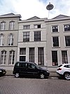 Huis onder schilddak en met empire lijstgevel, gepleisterd, voorzien van cordonlijsten en schuiframen