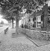 Overzicht voorgevel woonhuis met bomen aan de straat - Nuenen - 20338019 - RCE -  Voormalige Pastorie / Werkatelier En Woonhuis Geweest Van Vincen: Overzicht voorgevel woonhuis met bomen aan de straat 