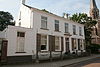 Ossendrecht - Dorpsstraat 3 - Voormalige notariswonin.JPG -  Het huis dateert uit 1860; het was oorspronkelijk een eenlaags huis maar kreeg omstreeks 1900 een verdieping. Het heeft een in blokverband gepleisterde voorgevel met kroonlijst. 