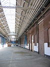 WLM - Minke Wagenaar - 10-06-27 De Hallen Amsterdam 009 - Voormalige tramremise aan het Bellamyplein in Amsterdam Oud-West. Rijksmonument o.a. vanwege de 'Polonceau' spanten. Zeldzaam voorbeeld ervan in Nederland. Antoine-RÃ©my Polonceau (Reims, 1778 - Roche-lez-BeauprÃ©, 1847) was een Franse ingenieur. Hij bouwde de Simplontunnel. Hij is Ã©Ã©n van de 72 Fransen wier namen op de Eiffeltoren gegrift staan. En hij is de uitvinder van dit type spant . . . 