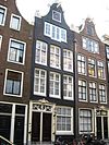 Pand met klokgevel met gekuifde deuromlijsting en louis