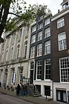 Pand met klokgevel van zware vormen met gesneden deuromlijsting