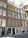 Twee smalle woningen achter gemeenschappelijke lijstgevel met geblokte pui