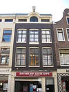 Pand met gevel onder in het midden verhoogde lijst met twee consoles