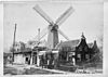 Overzicht van paltrokmolen en omliggende bebouwing - Amsterdam - 20022102 - RCE -  De Otter: Overzicht van paltrokmolen en omliggende bebouwing (opmerking: Reproductie van oude foto) 