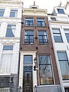 Huis met gevel onder rechte lijst met consoles