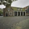 Overzicht voorgevel cafÃ© met houten zuilen