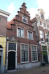 Kleine Houtstraat 116 RM19433 -  This house that was restored in 1932 still has the heraldic shield of the St. Elisabeth Gasthuis above the doorway. It shows three crowns. The hospital was formerly located behind this house with the main entrance on the Gasthuisvest. Kleine Houtstraat 116, Haarlem 