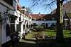 Hofje-van-loo.JPG - Hofje van Loo or 'Gasthuishofje'. Located at Barrevoetstraat 7. The hofje foundation dates from 1489, and the houses date from the 17th century. Due to the long iron gate at the streetside of the hofje, this is one of the most photographed hofje in Haarlem.