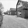 Houten huis met zolderverdieping onder mansarde kap