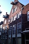 Onderkelderd huis met tuitgevel voorzien van vlechtingen