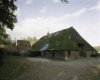 Overzicht van de deel van de boerderij met rieten dak en zicht op aanbouw
