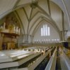 Interieur naar het noordwesten met orgel links en bankenplan