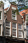 Pand met klokgevel met fronton en met jongere onderpui