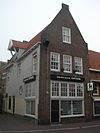 Huis met aan de Muurhuizenzijde gepleisterde gevel met hijsluik.