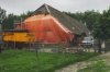 Overzicht afgebroken linker zijgevel en deel voorgevel, met oranje bouwzeil overspannen