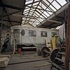 Interieur overzicht remise en werkplaats met locomotieven - Goes - 20344623 - RCE -  Spoorbaantraject Van De Spoorwegremise In Goes Naar Oudelande: Interieur overzicht remise en werkplaats met locomotieven 