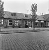 Eenvoudig huis met langsgevel aan de zijde van het kerkplein