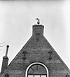 Windvaan, in de vorm van een leeuw die een Davidster vasthoudt, op de top van de puntgevel van de voormalige synagoge te Zierikzee - Zierikzee - 20222646 - RCE -  Voormalige synagoge/ Voormalige Synagoge: Windvaan, in de vorm van een leeuw die een Davidster vasthoudt, op de top van de puntgevel van de voormalige synagoge te Zierikzee 