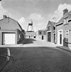 Ronde stenen stellingmolen van opzij gefotografeerd, gezien vanuit het dorp - IJzendijke - 20352886 - RCE -  De Witte Juffer: Ronde stenen stellingmolen van opzij gefotografeerd, gezien vanuit het dorp (opmerking: Gefotografeerd voor Monumenten In Nederland Zeeland) 