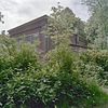 Sponningen in de zijgevel - Oostkapelle - 20343066 - RCE -  Hertenkamp: Overzicht zijgevel en achtergevel oranjerie met lange smalle vensters / sponningen in de zijgevel 