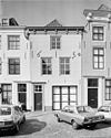 Huis met gepleisterde lijstgevel. Eenvoudige voordeuromlijsting. Stoep