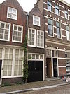 Langwerpig smal huis met aan de voor- en achterzijde puntgevel met vlechtingen. Achtergevel aan de Voorstraathaven: roedenverdeling stijl. Voorgevel vernieuwd