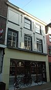 Huis met gecementeerde lijstgevel met in de verdieping empire-ramen en in de zolderverdieping ramen in stijl