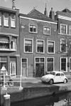 Pand met fragment van gevel met rechte kroonlijst, vroeger topgevel. Bogen boven raam