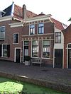 Huis met lijstgevel, waarin oude kozijnen en oorspronkelijke deur