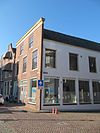 Pand, risalerende gepleisterde voorgevel. Aan de achterzijde een puntgevel